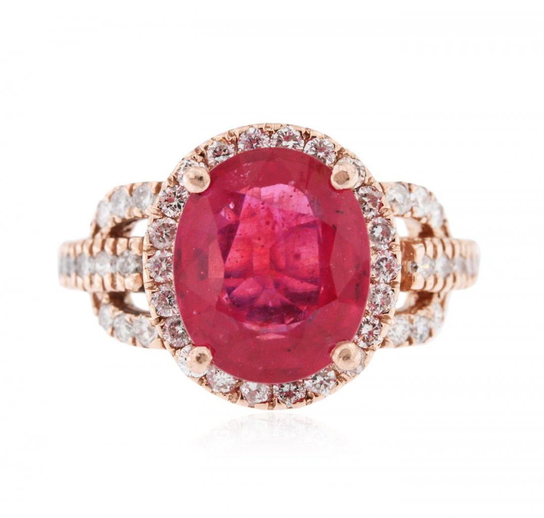 14KT Rose Gold 5.64ct Ruby and Diamond Ring: One electronically tested 14KT rose gold ladies cast ruby and diamond ring with a bright polish finish. Identified with markings of "14K". Condition is new. Containing: One prong set oval modified bri