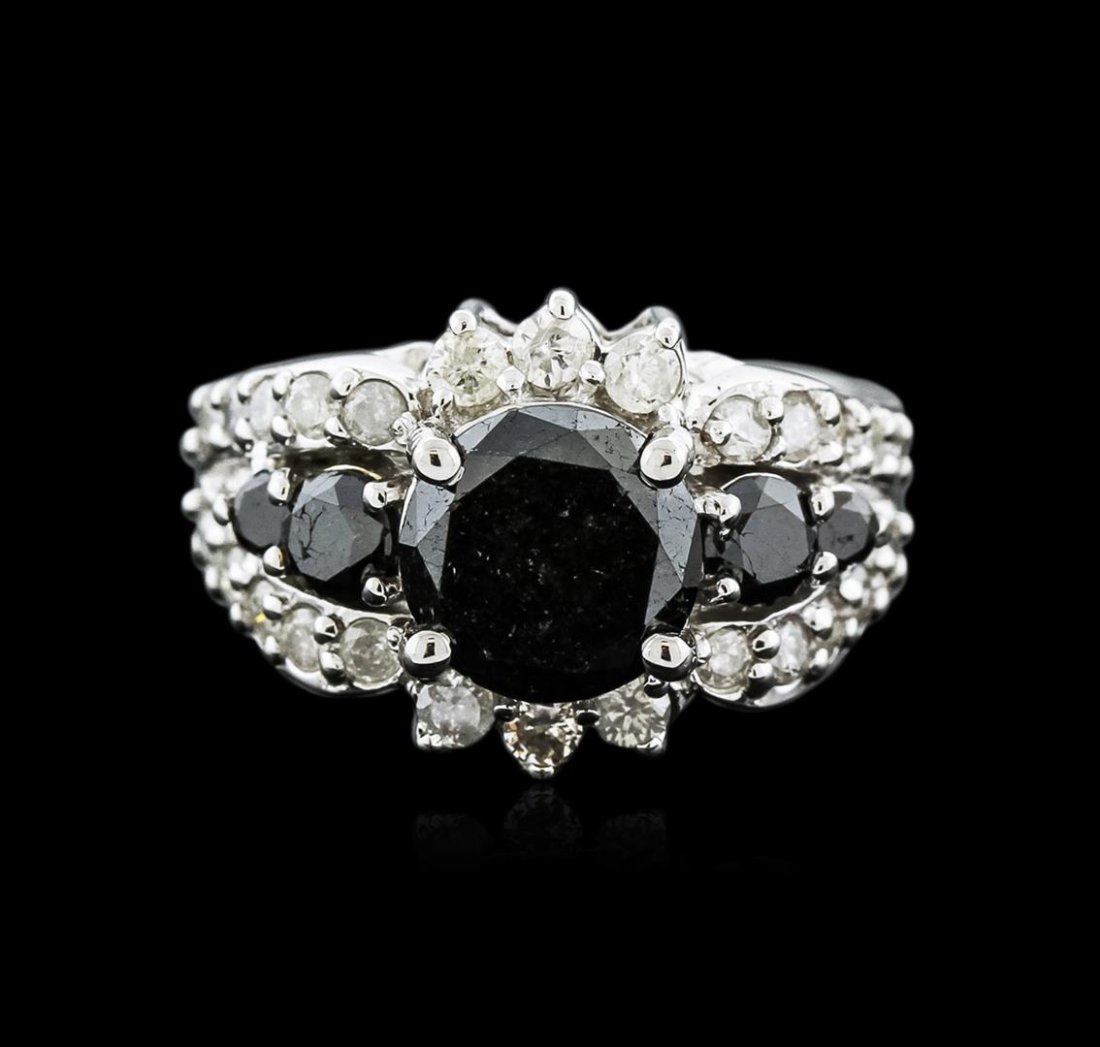 14KT White Gold 3.96ctw Black Diamond Ring: One electronically tested 14KT white gold ladies cast black and white diamond ring with a bright polish finish. The ring features a tapering black diamond ribbon set within mirroring white diamond rib