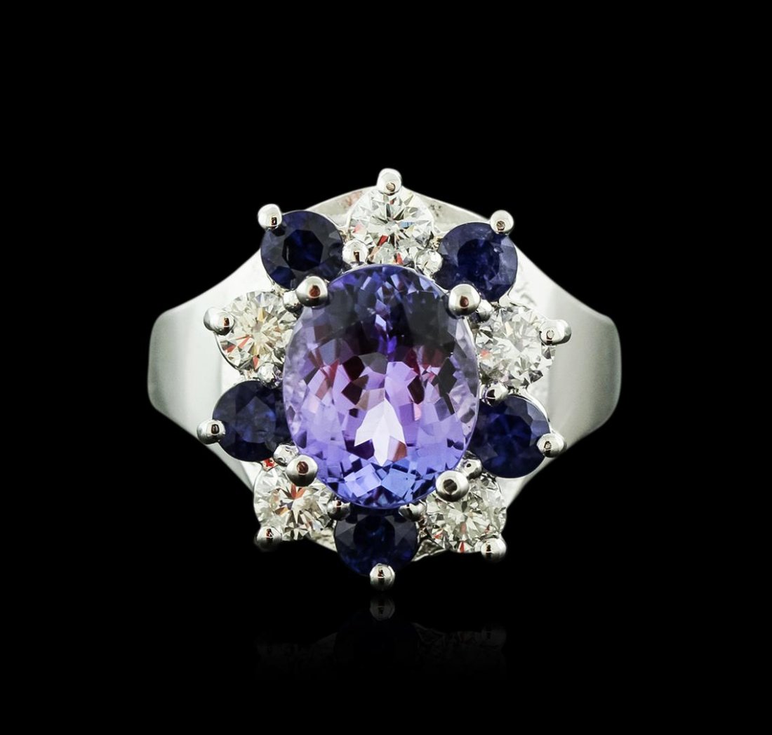 14KT White Gold 2.48ct Tanzanite, Sapphire and Diamond: One electronically tested 14KT white gold ladies cast tanzinite, sapphire and diamond ring with a bright polish finish. Identified with markings of "K14". Condition is new. Containing: One prong set o