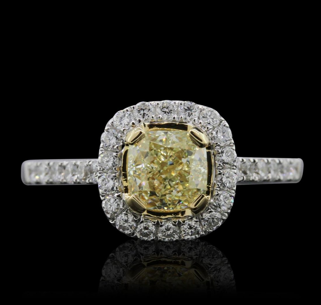 18KT White Gold 1.56ctw Fancy Yellow Diamond Ring: One electronically tested 18KT white gold ladies cast diamond ring with a bright polish finish. Condition is new, good workmanship. The featured diamond is mounted in a yellow gold accented basket, se