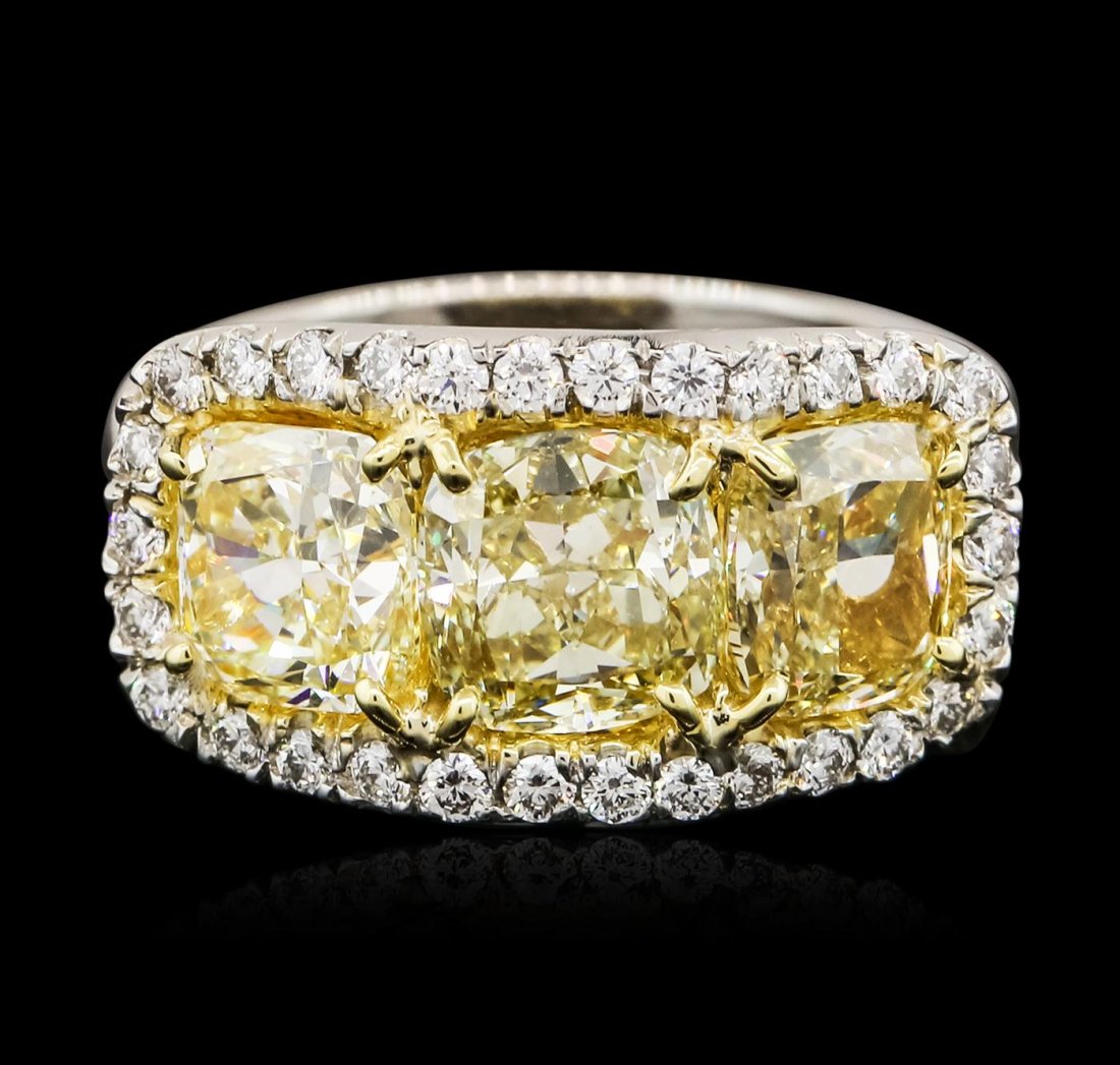 Platinum EGL USA Certified 5.69ctw Fancy Yellow Diamond: One electronically tested platinum ladies cast diamond ring with a bright polish finish. The ring features a diamond trio set within inner yellow gold baskets and an outer diamond set bezel supported 