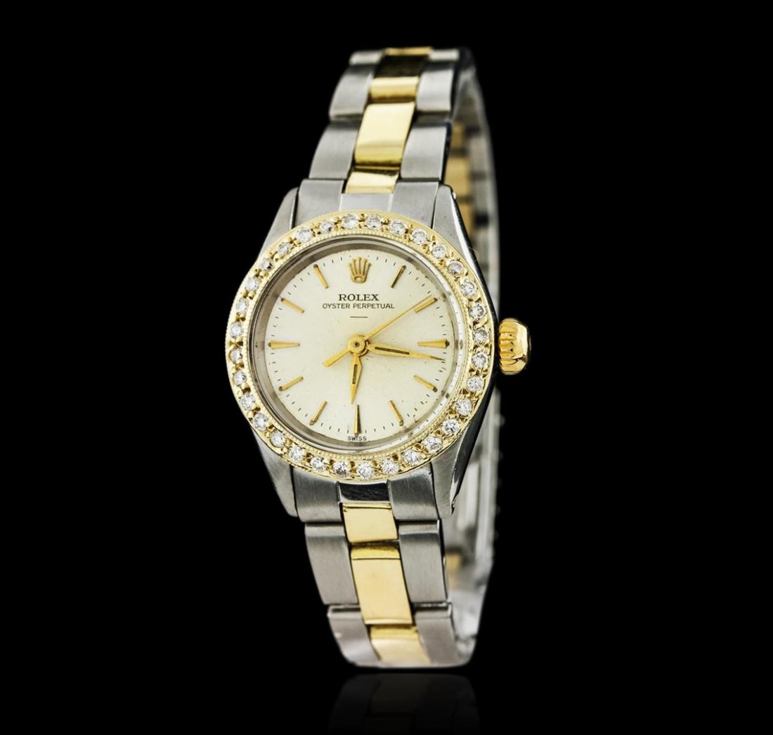 Ladies Rolex Two-Tone Diamond Oyster Perpetual: One ladies, Rolex Oyster Perpetual Model wristwatch electronically tested, Stainless Steel Case: 25mm oyster, 14KT yellow gold Crown: twinlock with logo, Custom Bezel: diamond set, Crystal: acrylic le