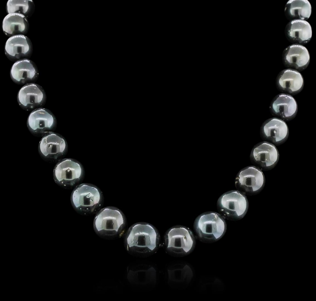 14KT White Gold Tahitian Pearl Necklace: One graduated, single strand Cultured Tahitian Pearl necklace. The strand has each pearl individually hand knotted and measures 17 inches in length. The necklace is finished with a scalloped 14K white