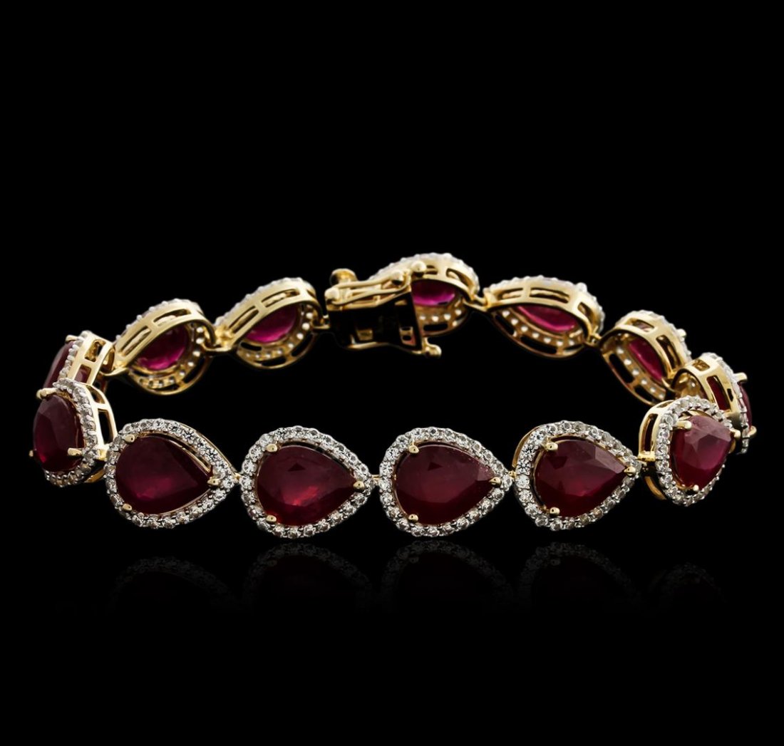 SILVER 31.67ctw Ruby and White Sapphire Bracelet: One bracelet featuring: 925 sterling silver weighing 20.30 grams containing 13 slightly purplish red pear shape rubies with a total weight of 31.67ct. Avg. Meas.: 10.00 x 7.00mm. Clarity: Heavily Incl