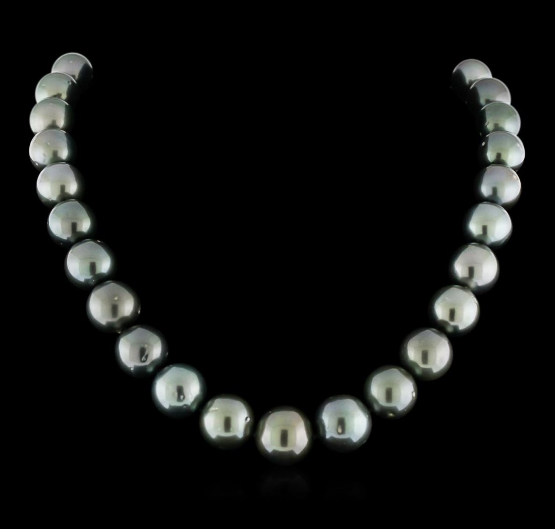Tahitian Cultured Pearl Necklace with 14KT White Gold: One graduated single strand pearl necklace 18.0" princess length, knotted with a 14KT white gold clasp containing 31 Tahitian pearls, 13.0mm in size to 16.0mm in size. The pearls are black in color wi