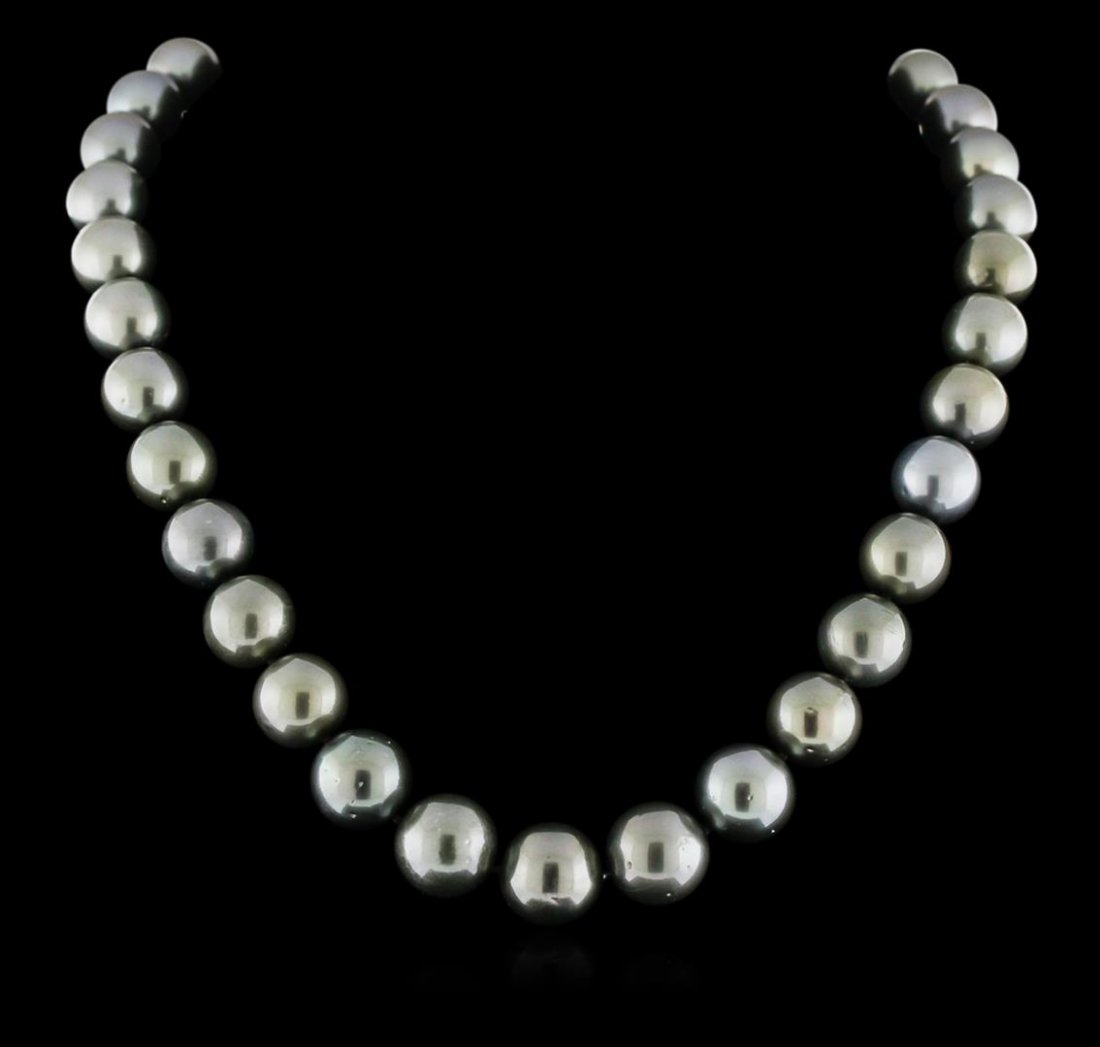 Tahitian Cultured Pearl Necklace with 14KT White Gold: One graduated single strand pearl necklace 18.5" princess length, knotted with a 14KT white gold clasp containing 35 Tahitian pearls, 11.0mm in size to 13.5mm in size. The pearls are black in color wi