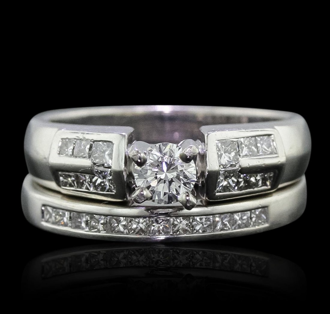 Platinum 0.94ctw Diamond Ring Wedding Set: One electronically tested platinum Ladies cast engagement ring & wedding band with a bright polish finish. Condition is new. Identified with markings of "PT 900". Containing: One prong set round brill