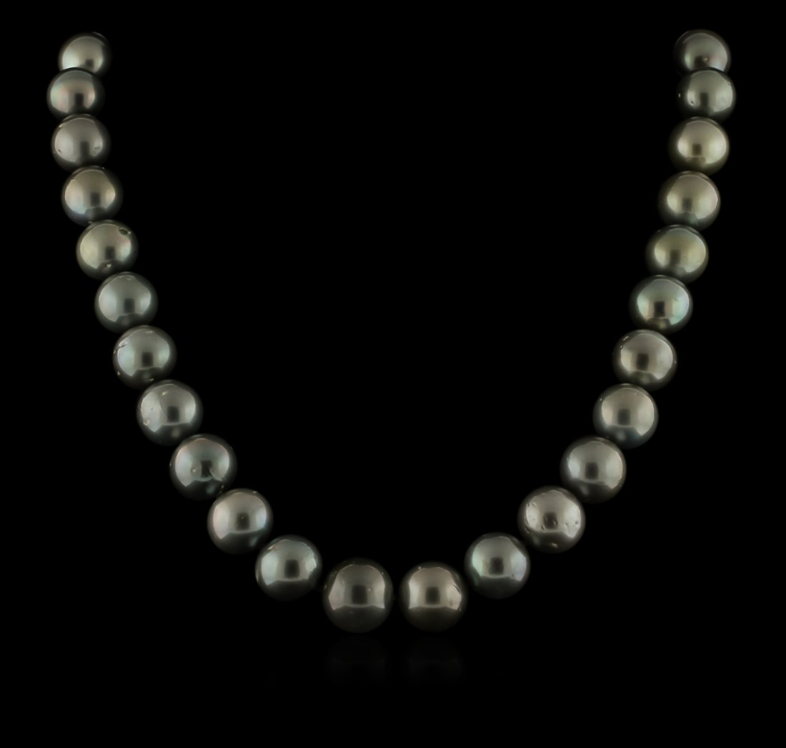 Tahitian Cultured Pearl Necklace With 14KT White Gold: One graduated single strand pearl necklace 18.0" princess length, knotted with a 14KT white gold clasp containing 33 Tahitian pearls, 12.0mm in size to 15.0mm in size. The pearls are black and silver 