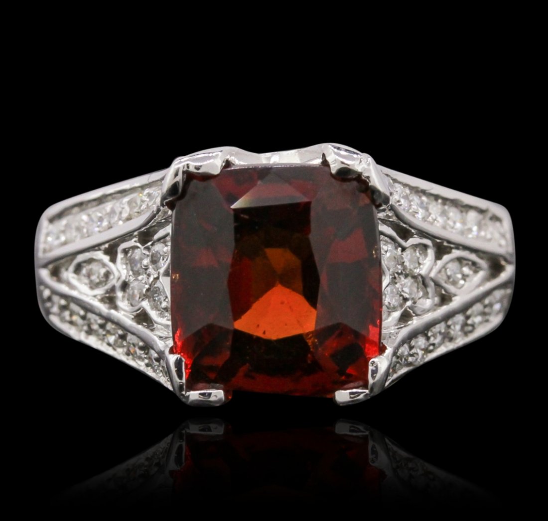 14KT White Gold 3.50ct Garnet and Diamond Ring: One ring featuring: 14KT white gold with a total weight of 6.91 grams, garnet with a total weight of 3.50ct, and diamonds with a total weight of 0.75ctw.
