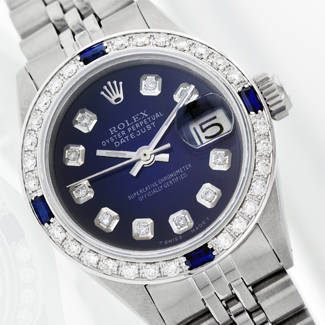 Rolex Stainless Steel Diamond and Sapphire DateJust: One Ladies Rolex Datejust Polished Bright with Satin Finish, Serviced & Electronically Tested, Stainless Steel Case: 26mm, Stainless Steel Crown, Custom Bezel: 18K White Gold Sapphire Beadset Diamond 
