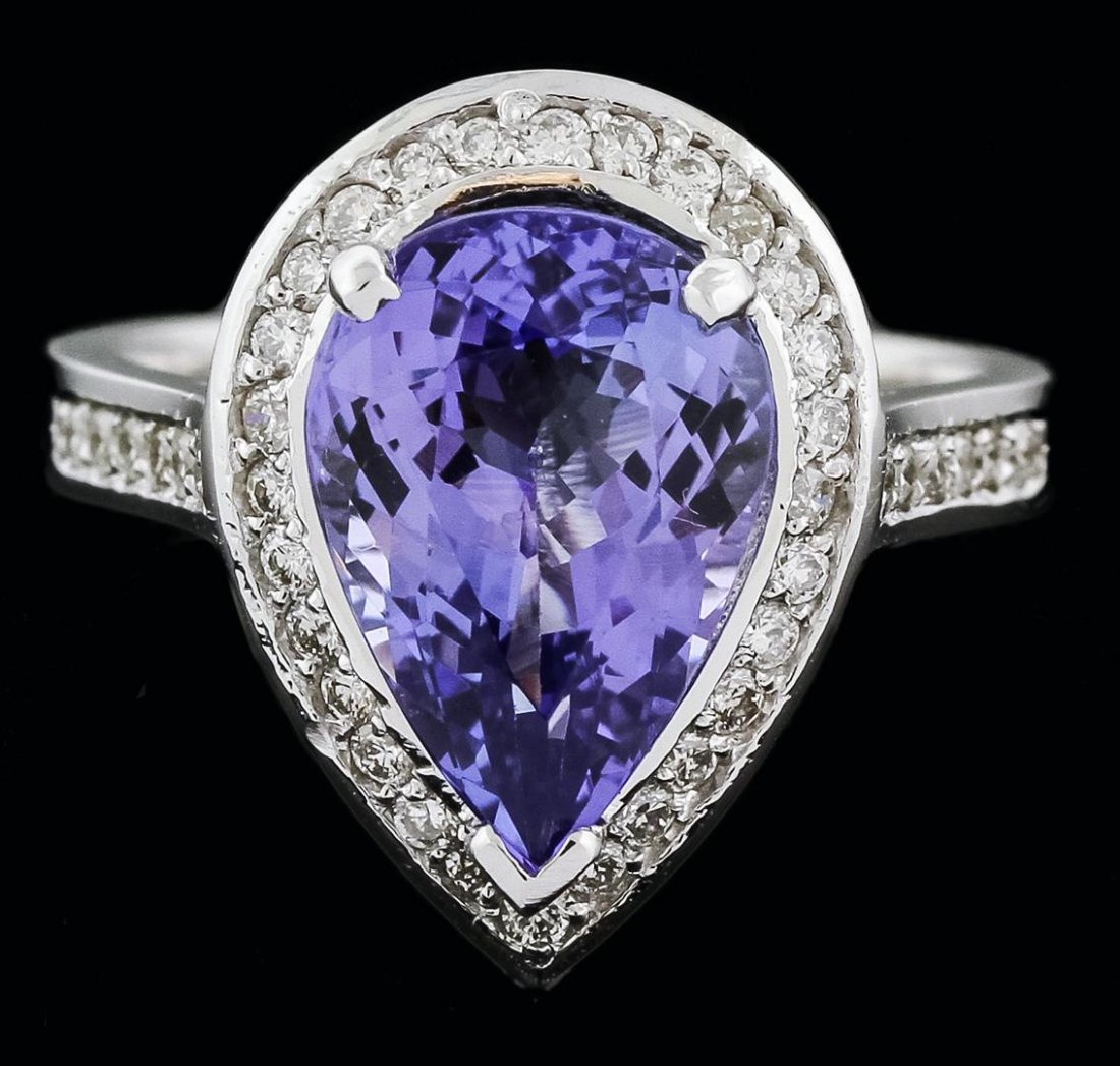 14KT White Gold 4.13ct Tanzanite and Diamond Ring: One electronically tested 14KT white gold ladies cast tanzanite and diamond ring with a bright polish finish. Identified with markings of "K14". Condition is new. Containing: One prong set pear modifi