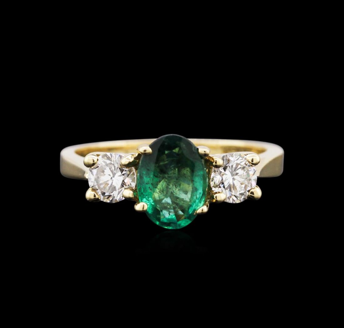 1.07ct Emerald and Diamond Ring - 14KT Yellow Gold: One electronically tested 14KT yellow gold ladies cast emerald and diamond ring with a bright polish finish. Identified with markings of "14K". Condition is new. Containing: One prong set oval modifie
