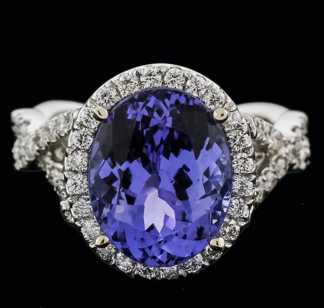 14KT White Gold 5.12ct Tanzanite and Diamond Ring: One electronically tested 14KT white gold ladies cast tanzanite and diamond ring with a bright polish finish. Identified with markings of "K14". Condition is new. Containing: One prong set oval modifi