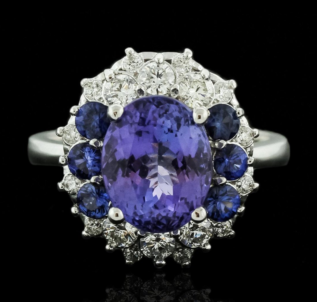 14KT White Gold 3.07ct Tanzanite, Sapphire and Diamond: One electronically tested 14KT white gold ladies cast tanzanite, sapphire and diamond ring with a bright polish finish. Identified with markings of "K14". Condition is new. Containing: One prong set o