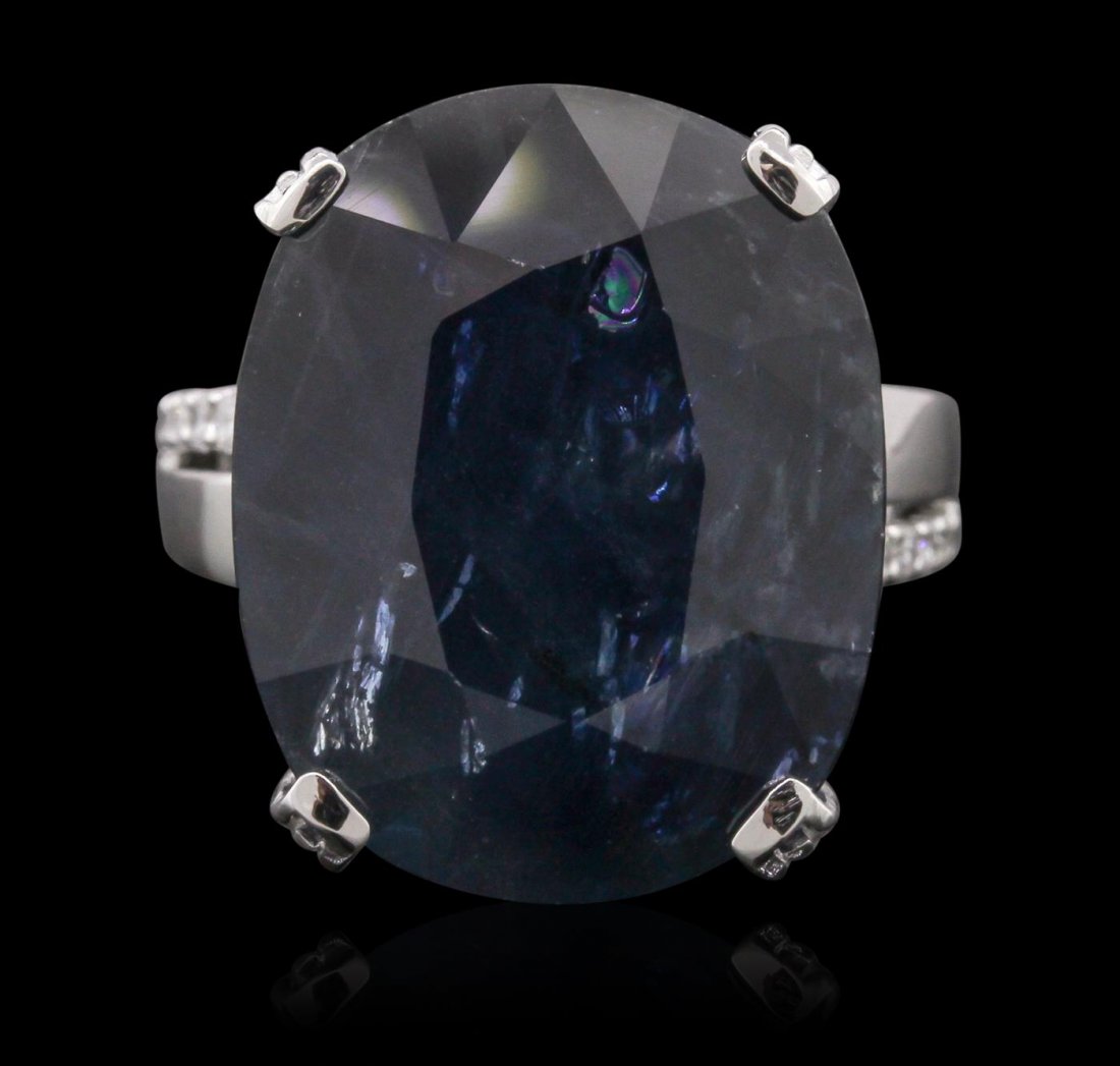 18KT White Gold 25.99ct Sapphire and Diamond Ring: One electronically tested 18KT white gold Ladies combination cast & assembled ring with a bright polish finish. Condition is new. Identified with markings of "18K". Containing: One prong set oval modi