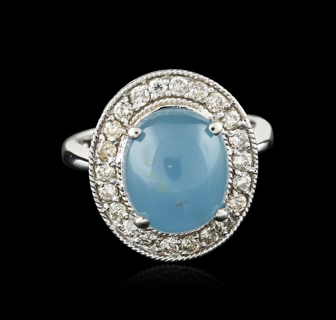 14KT White Gold 6.45ct Aquamarine and Diamond Ring: One electronically tested 14KT white gold ladies cast aquamarine and diamond ring with a bright polish finish. Identified with markings of "K14". Condition is new. Containing: One prong set oval caboc