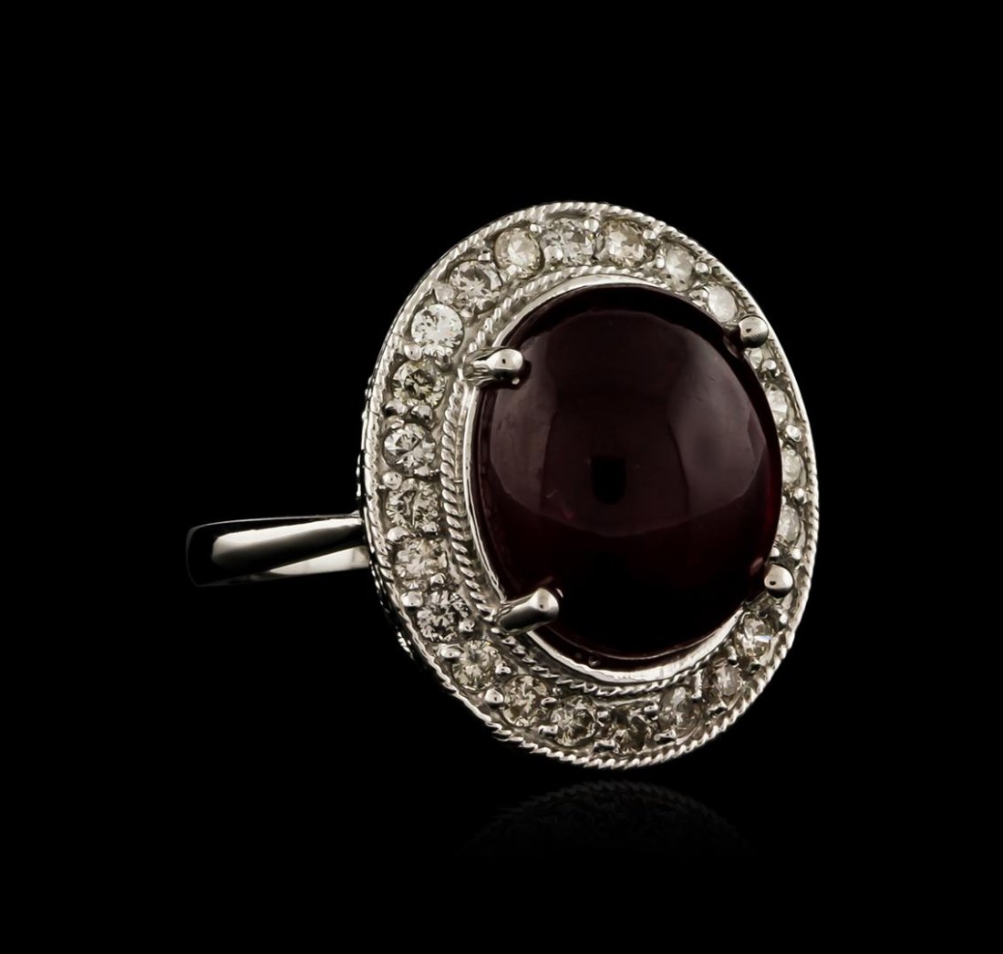 14KT White Gold 13.92ct Ruby and Diamond Ring: One electronically tested 14KT white gold ladies cast ruby and diamond ring with a bright polish finish. Identified with markings of "14K". Condition is new. Containing: One prong set oval cabochon cu