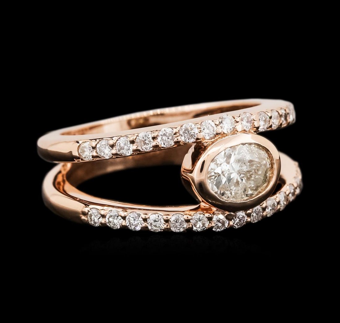 14KT Rose Gold 0.96ctw Diamond Ring: One electronically tested 14KT rose gold ladies cast diamond engagement ring with a bright polish finish. Identified with markings of "14K". Condition is new. Containing: One bezel set oval shaped cut