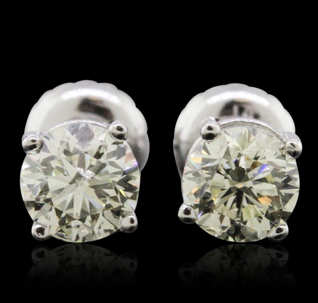 14KT White Gold 1.02ctw Diamond Solitaire Earrings: One pair electronically tested 14KT white gold cast & assembled diamond solitaire earrings with screw backs. Condition is new, good workmanship. Containing: One prong set round brilliant cut diamond,