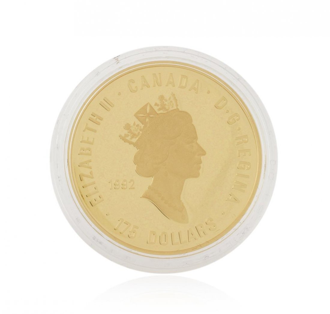 1992 Olympic Centennial Gold Coin: This exquisite gold coin salutes the Olympic Vision and the ability of the Olympic Movement to bring all the world's people together in pursuit of the Olympic ideal. The Olympic Flame is symbolically