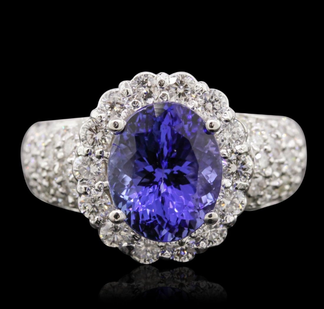 14KT White Gold 3.94ct Tanzanite and Diamond Ring: One electronically tested 14KT white gold Ladies cast ring with a bright polish finish. Condition is new. Identified with markings of "14K". Containing: One prong set oval modified brilliant cut natur