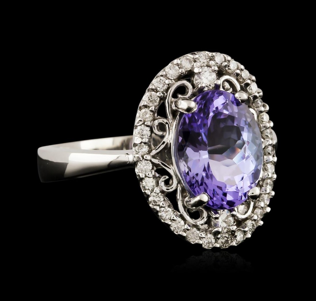 14KT White Gold 2.95ct Tanzanite and Diamond Ring: One electronically tested 14KT white gold ladies cast tanzanite and diamond ring with a bright polish finish. Identified with markings of "K14". Condition is new. Containing: One prong set oval modifi