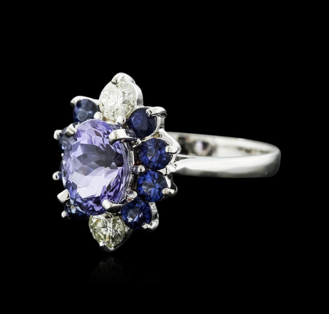 14KT White Gold 1.90ct Tanzanite, Sapphire and Diamond: One electronically tested 14KT white gold ladies cast tanzinite, sapphire and diamond ring with a bright polish finish. Identified with markings of "K14". Condition is new. Containing: One prong set o