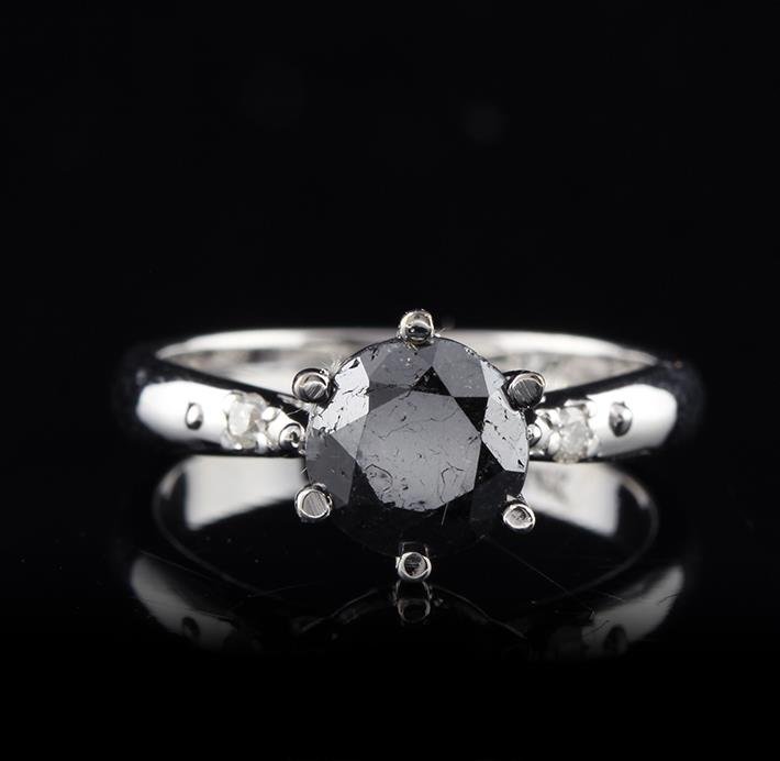 14KT White Gold 1.50ct Black Diamond Ring: One electronically tested 14KT white gold ladies cast black and white diamond ring with a bright finish. Condition is new, good workmanship. The cathedral set black diamond is accented by a single whi