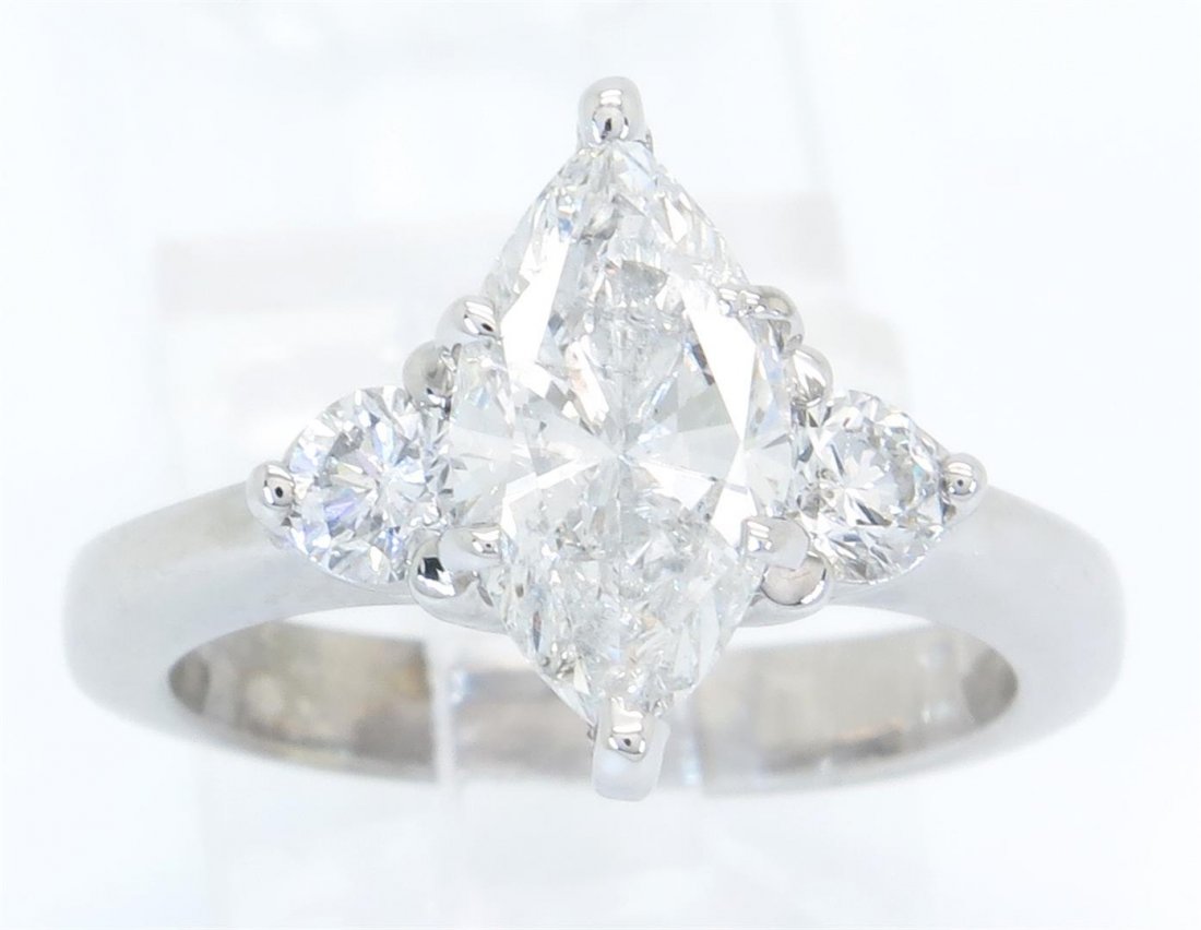 1.86ctw Certified Diamond Ring - 14K White Gold: One tested 14K white gold certified diamond ring. Containing: One IGI Certified Marquise Cut Diamond. Size: 1.52CT, Clarity: I1, Color: G. Two Round Brilliant Cut Diamonds. Approximate total diamond w