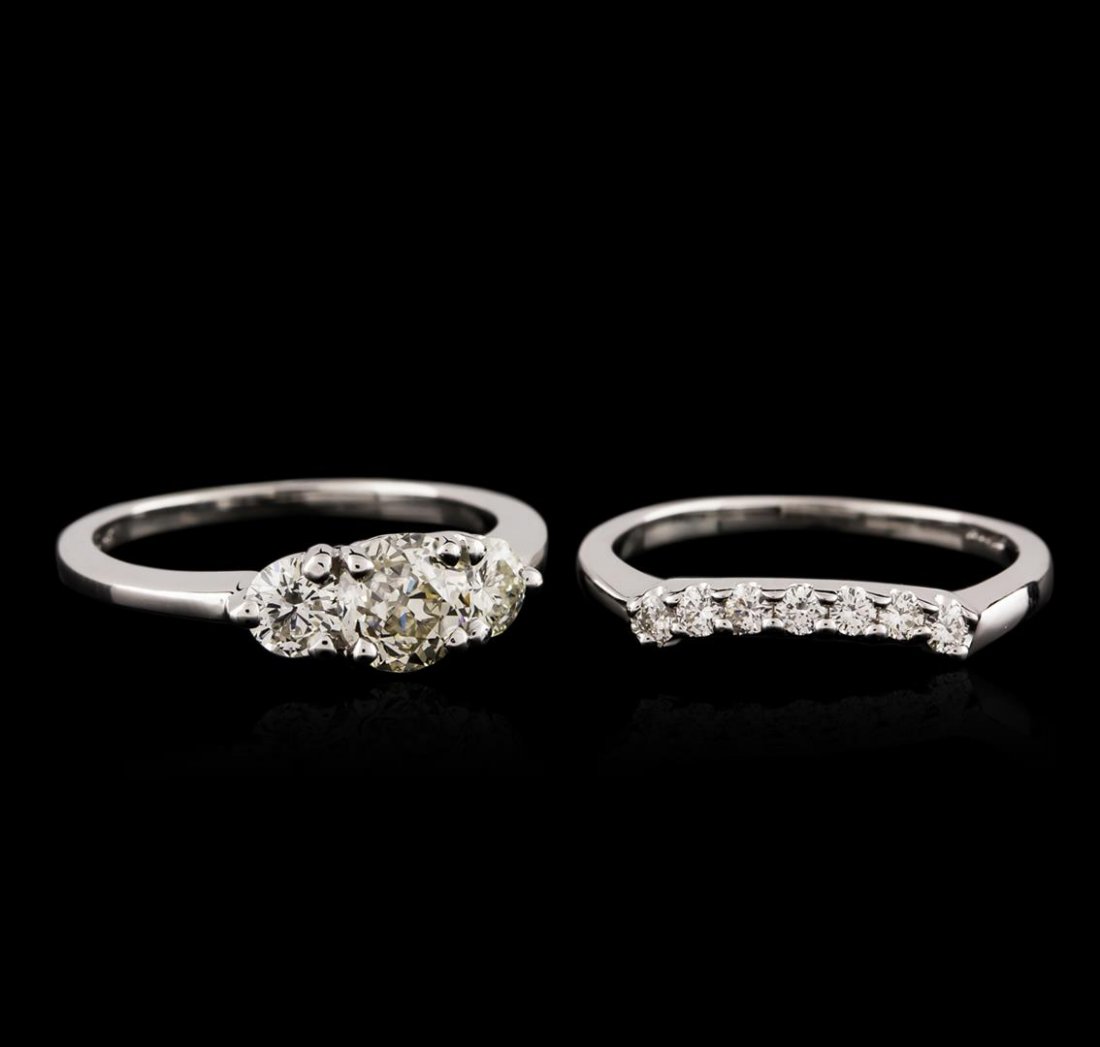 14KT White Gold 1.57ctw Diamond Wedding Ring Set: One electronically tested 14KT white gold ladies cast diamond engagement ring & wedding band with a bright polish finish. Identified with markings of "14K". Condition is very good. Containing: One pro