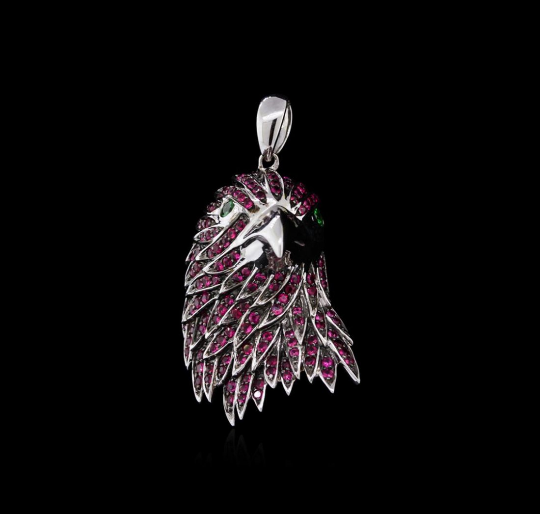 18KT White Gold 1.12ctw Ruby and Tsavorite Eagle: One eagle pendant featuring: 18KT white gold weighing 7.52 grams containing 146 hot pink rubies with a total weight of 1.12ct and 2 tsavorites with a total weight of 0.11ct.