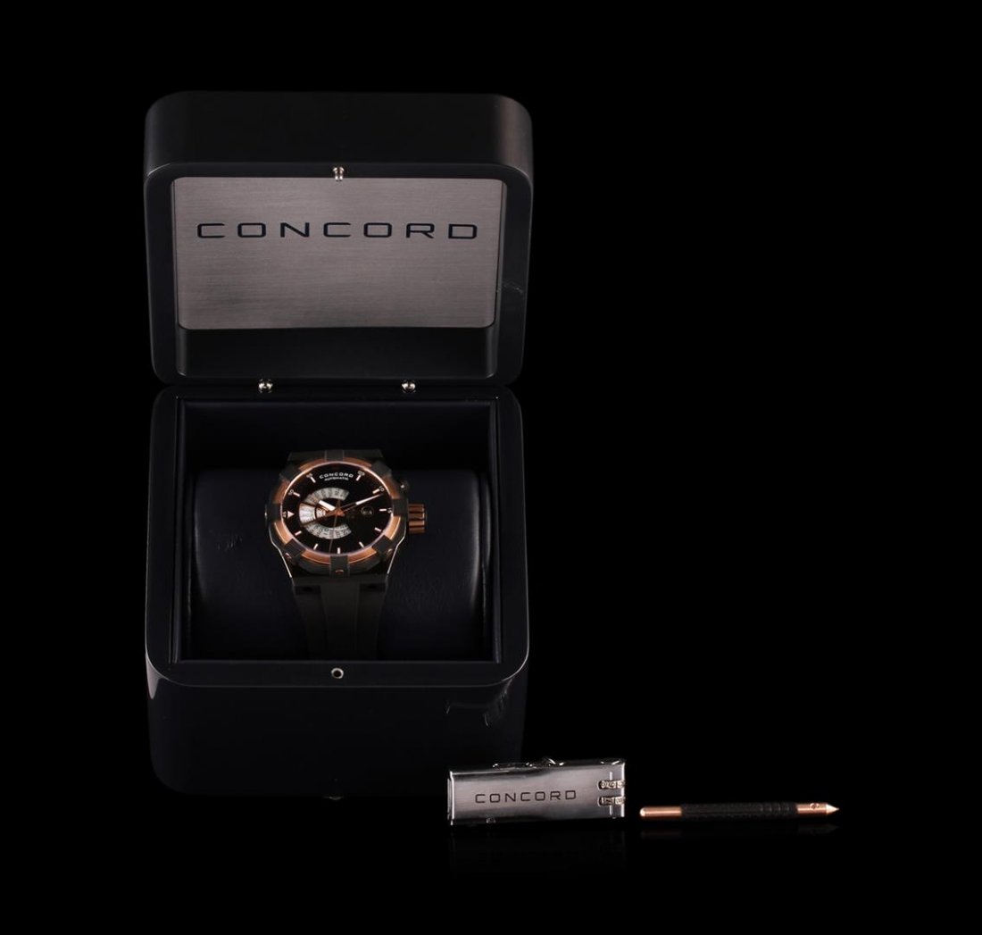 Concord 18KT Rose Gold C1 Worldtimer Watch: 100% AUTHENTIC , Brand New In Box, Unworn WITH ALL ORIGINAL PACKAGING AND DOCUMENTATIONS; Case: 18 k rose gold, stainless steel, rubber' Case-back: Screw-down; Bezel: 18 k rose gold, rubber; Dial: Bla