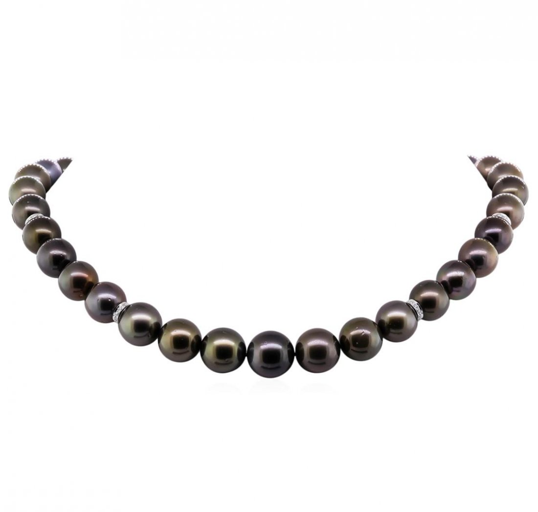 Tahitian Cultured Pearl and Diamond Necklace: One graduated single strand pearl necklace 18.0" princess length, knotted with a tongue clasp containing 35 Tahitian pearls, 11.1mm in size to 14.4mm in size. The pearls are black in color, green over