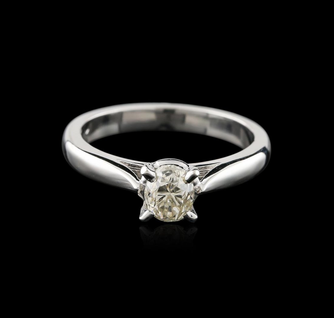 14KT White Gold 0.80ct Oval Cut Diamond Solitaire Ring: One electronically tested 14KT white gold ladies cast diamond solitaire ring with a cathedral shank with a bright polish finish. Identified with markings of "14K". Condition is new. Containing: One pr