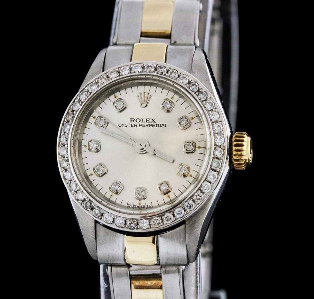 Rolex Two-Tone Diamond Oyster Perpetual Ladies Watch: One ladies, Rolex Oyster Perpetual Model wristwatch electronically tested, Stainless Steel Case: 25mm oyster, 14KT yellow gold Crown: twinlock with logo, Custom Bezel: diamond set, Crystal: acrylic le