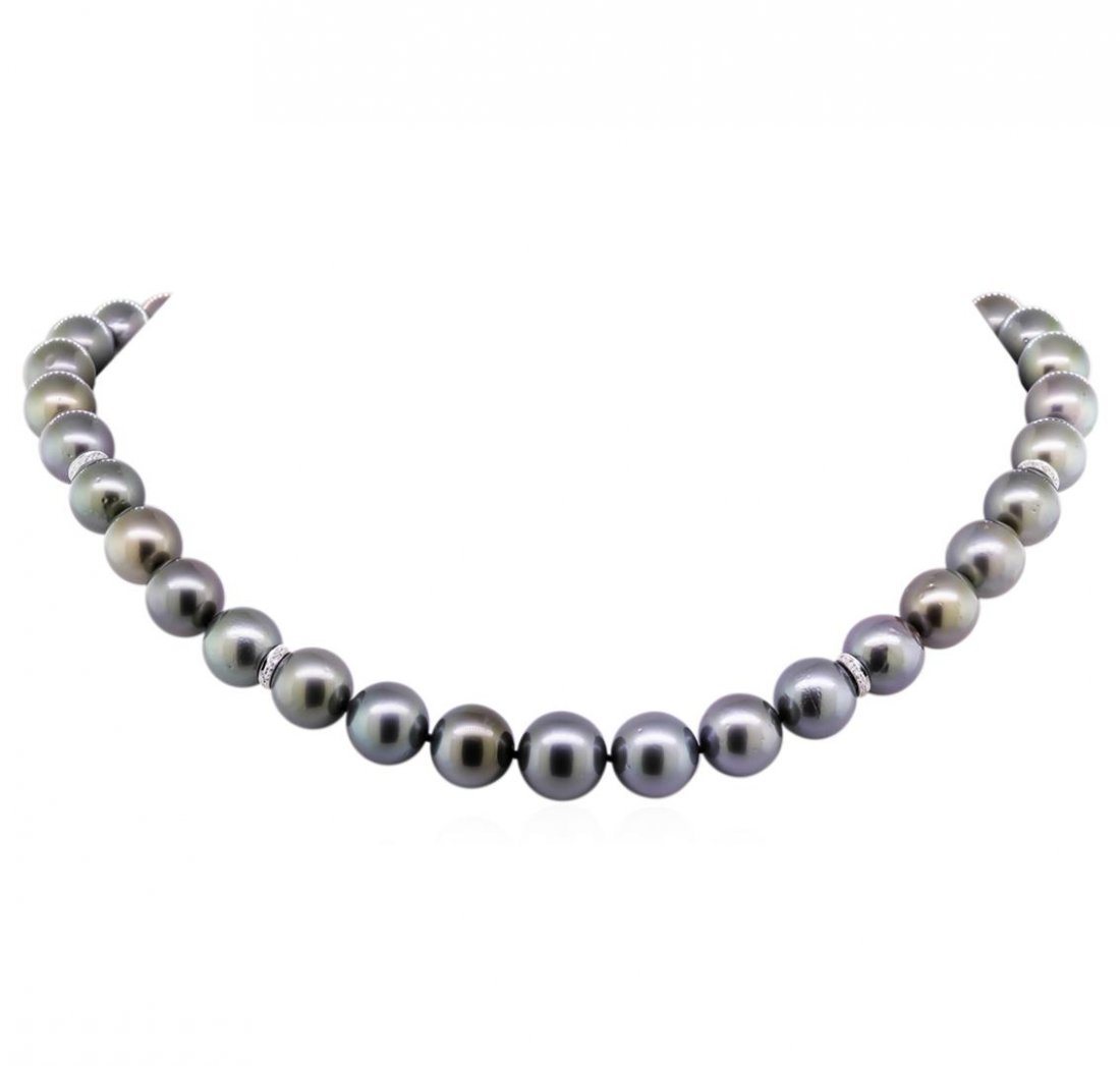 0.23ctw Tahitian Cultured Pearl and Diamond Necklace: One graduated single strand pearl necklace 17.5" princess length, knotted with a tongue clasp containing 37 Tahitian pearls, 10.1mm in size to 13.3mm in size. The pearls are silver in color, green ove