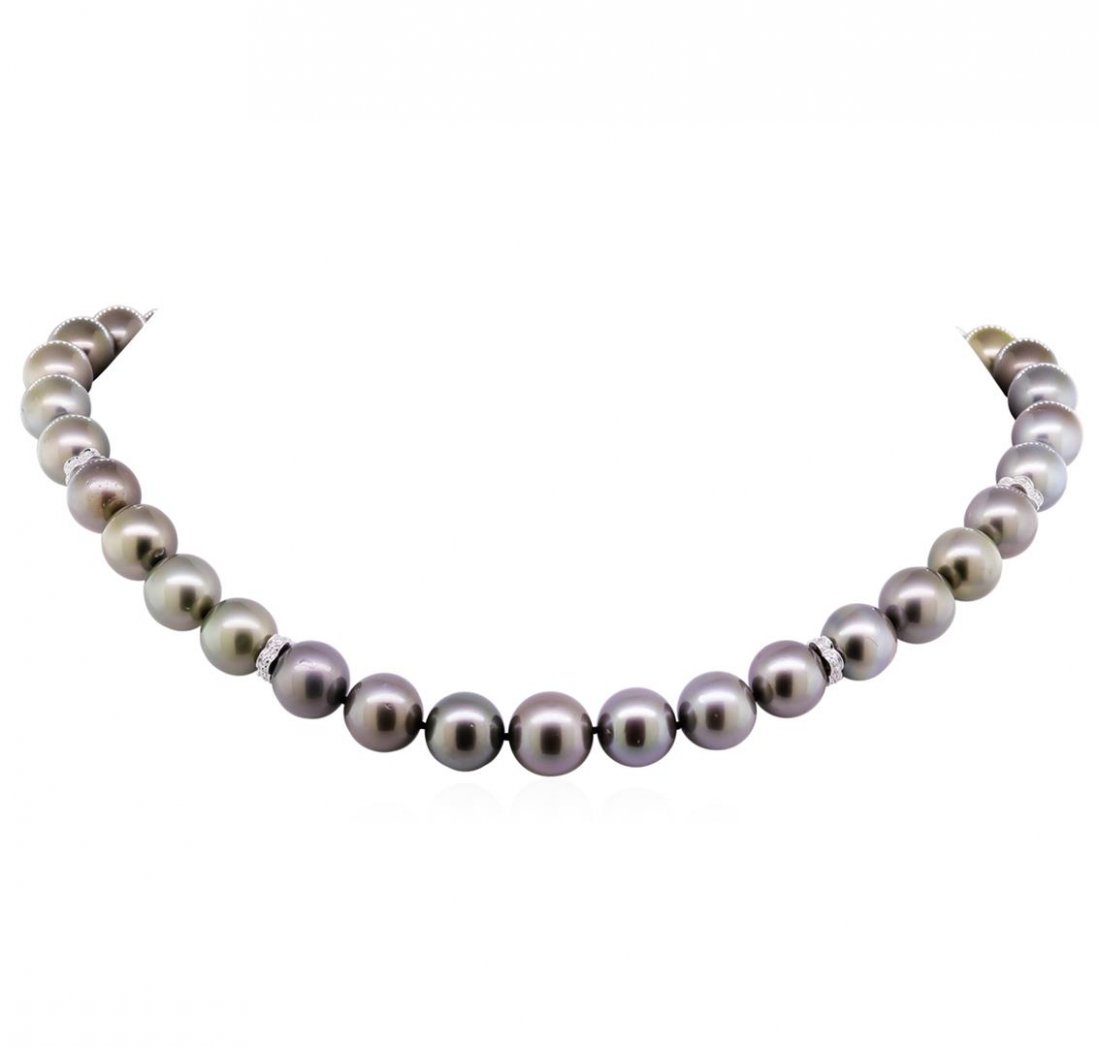 0.22ctw Tahitian Cultured Pearl and Diamond Necklace: One graduated single strand pearl necklace 17.5" princess length, knotted with a tongue clasp containing 37 Tahitian pearls, 10.1mm in size to 12.7mm in size. The pearls are silver in color, green ove