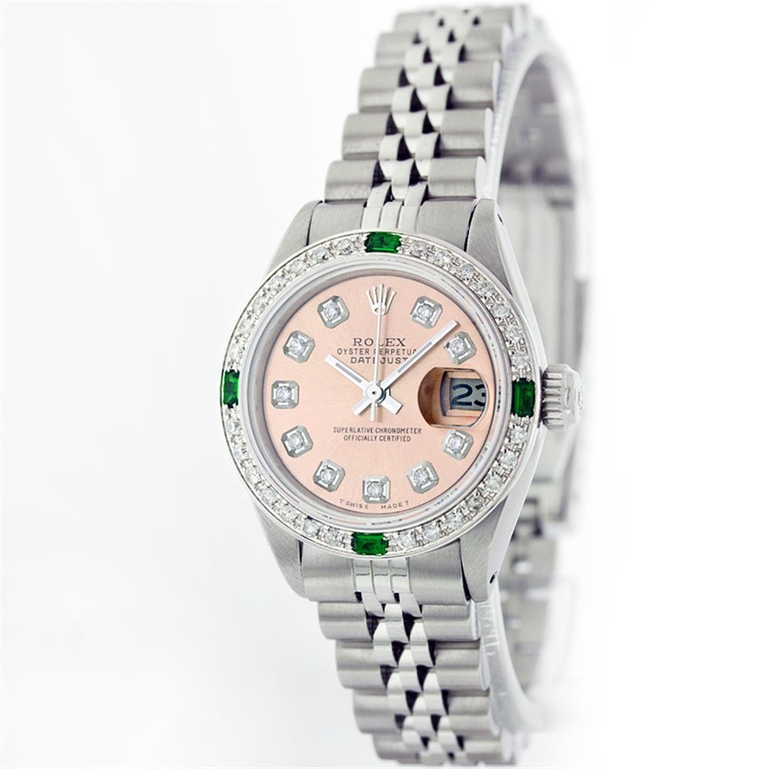 Rolex Stainless Steel Diamond And Emerald DateJust: One Ladies Rolex Datejust Polished Bright with Satin Finish, Serviced & Electronically Tested, Stainless Steel Case:26mm, Stainless Steel Crown, Custom Bezel: 18K White Gold Emerald Beadset Diamond Be