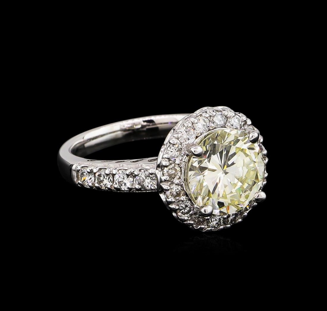 14KT White Gold 2.22ct SI-1/Light Yellow Diamond Ring: One electronically tested 14KT White Gold ladies cast diamond unity ring with a bright polish finish. Condition is new, good workmanship. The featured diamond is set within a diamond bezel supported b