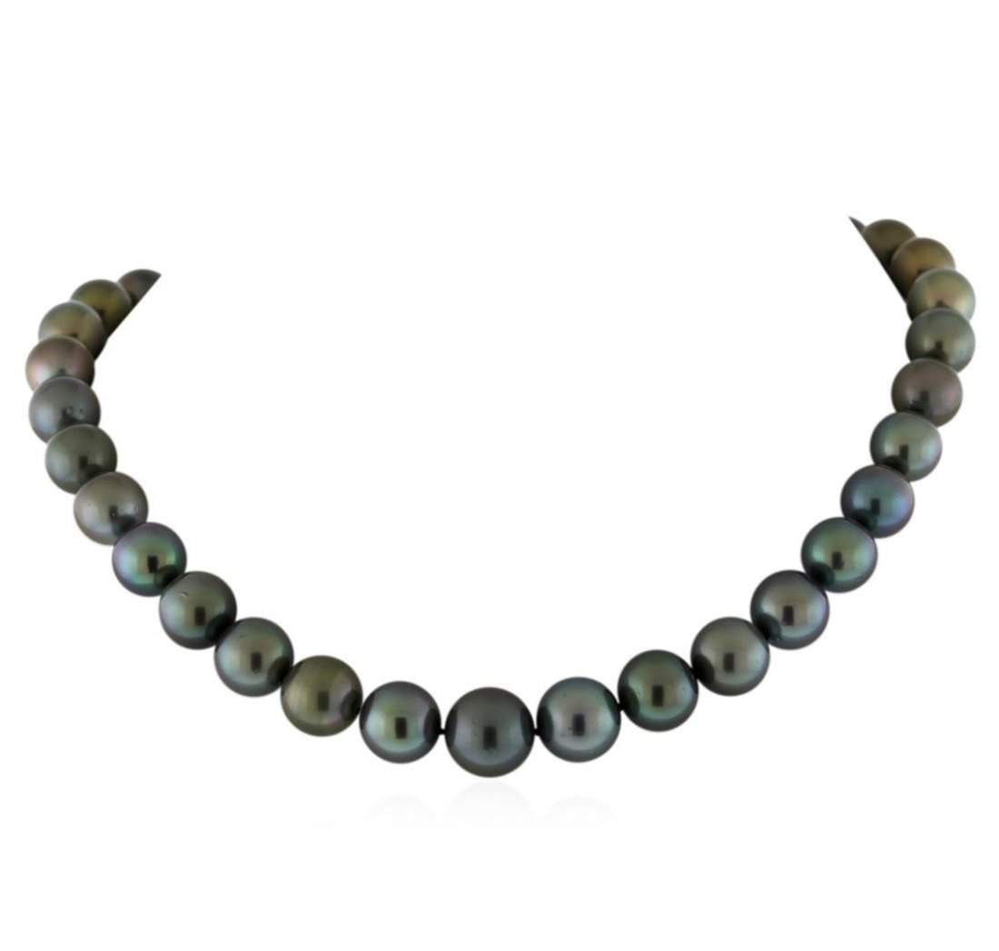 Tahitian Cultured Pearl Necklace With Diamond Clasp: One graduated single strand pearl necklace 18.0" princess length, knotted with a tongue clasp containing 35 Tahitian pearls, 11.1mm in size to 14.5mm in size. The pearls are silver in color, green ove