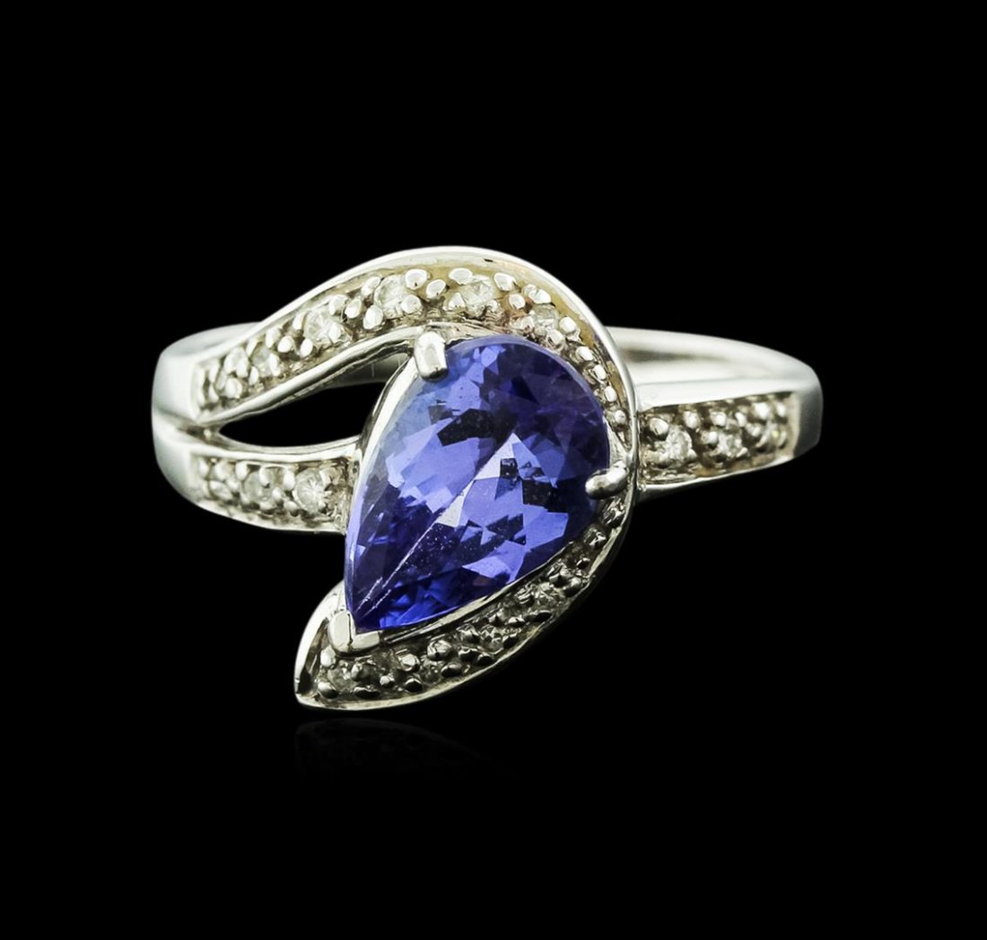 18KT White Gold 1.72 ctw Tanzanite and Diamond Ring: One electronically tested 18KT white gold ladies cast tanzanite and diamond ring with a bright polish finish. Identified with markings of "18K". Condition is new. Containing: One prong set pear modifi