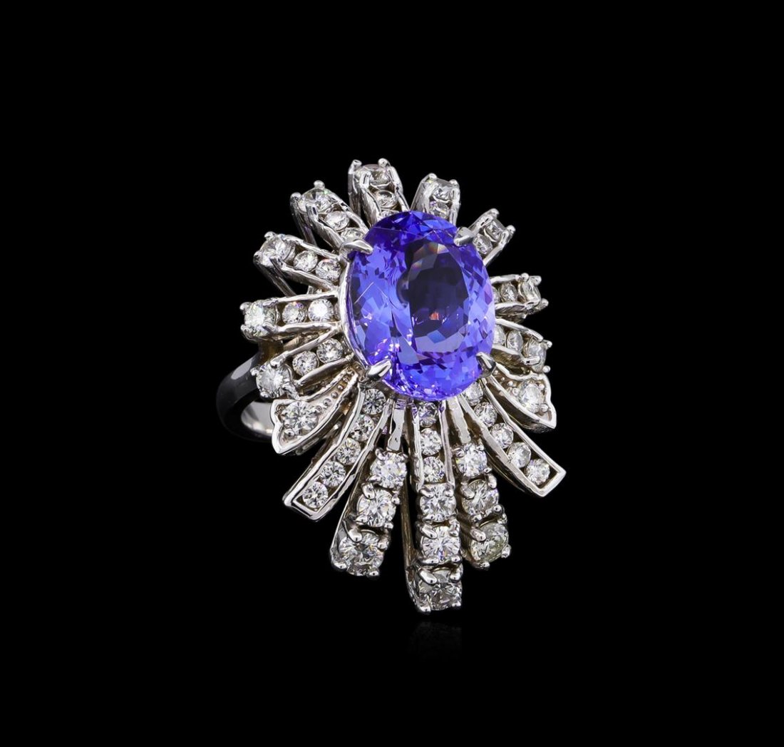 5.95 ctw Tanzanite and Diamond Ring - 14KT White Gold: One electronically tested 14KT white gold ladies cast tanzanite and diamond ring with a bright polish finish. The featured tanzanite is set within a floret of diamond ribbons, completed by a two milli