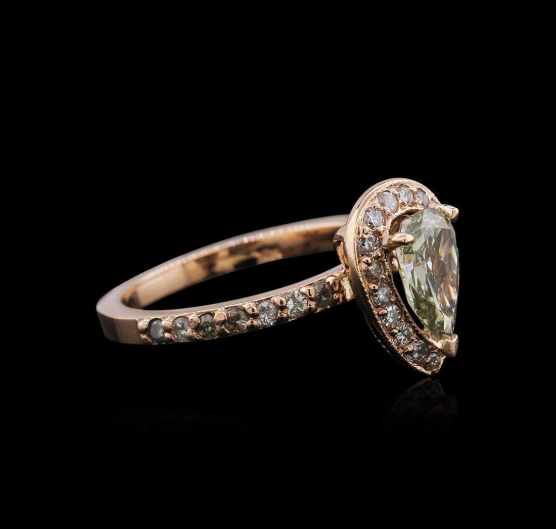 14KT Rose Gold 1.19 ctw Fancy Green Diamond Ring: One electronically tested 14KT rose gold ladies cast diamond ring with a bright polish finish. Identified with markings of "14K". Condition is new. Containing: One prong set pear shaped cut diamond, m