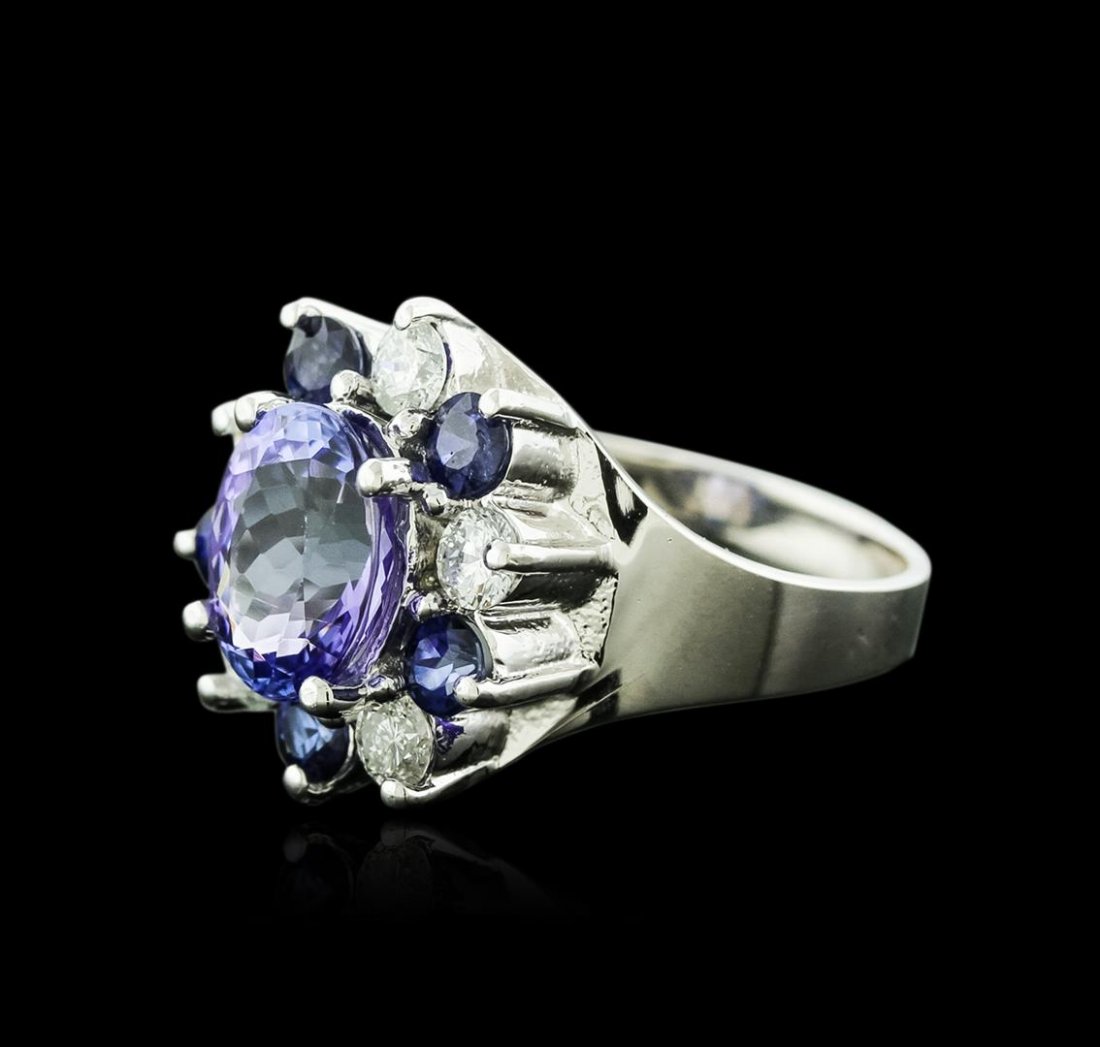 14KT White Gold 2.48 ctw Tanzanite, Sapphire and: One electronically tested 14KT white gold ladies cast tanzinite, sapphire and diamond ring with a bright polish finish. Identified with markings of "K14". Condition is new. Containing: One prong set o