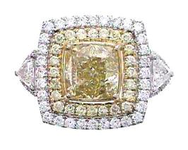 GIA Cert 4.23 ctw Fancy Yellow Diamond Ring - 18KT: One GIA certified 18KT two-tone gold ring weighing 8.08 grams containing: One modified square brilliant cut fancy yellow diamond weighing 2.82ct. Measurements: 7.56 x 7.54 x 5.29 mm. Color origin: Nat