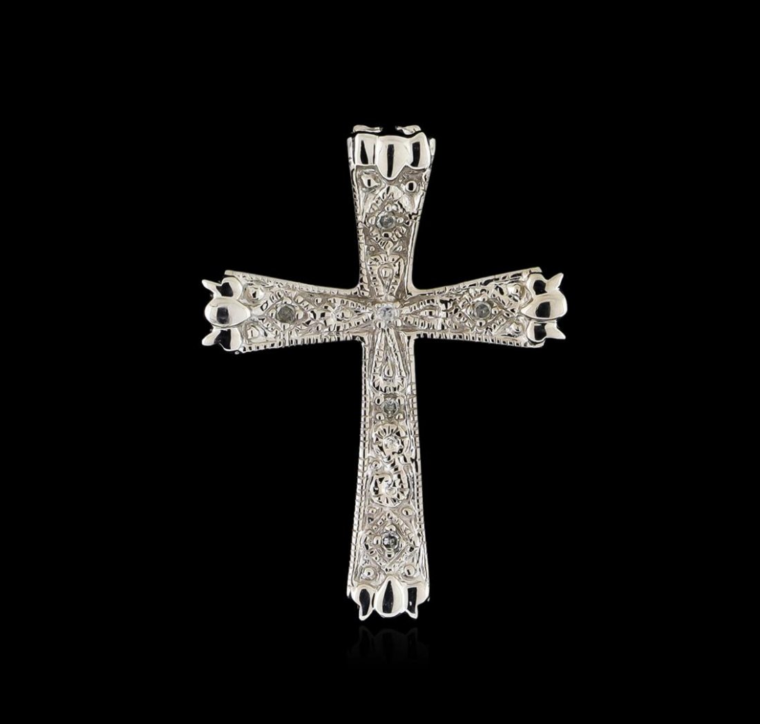 0.05 ctw Diamond Cross Pendant - 10KT White Gold: One 10KT white gold lady's cast cross pendant with a bright polish and milgrain detailing finish. Condition is new, good workmanship. Identified with markings of 10K". Containing: Six prong set single