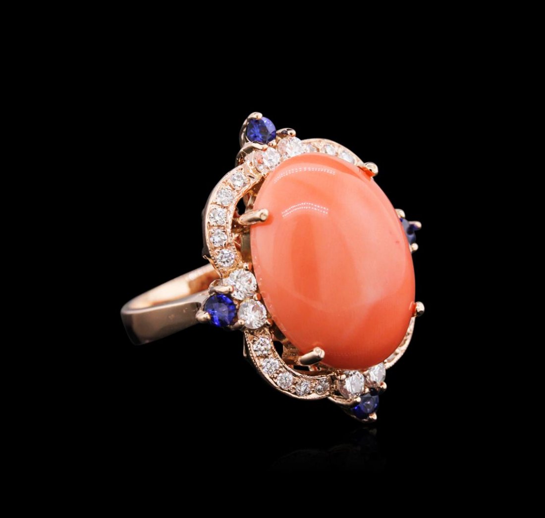 10.71 ctw Pink Coral, Blue Sapphire, and Diamond Ring -: One electronically tested 14KT rose gold ladies cast coral, sapphire and diamond ring with a bright polish finish. Identified with markings of "14K". Condition is new. Containing: One prong set oval c