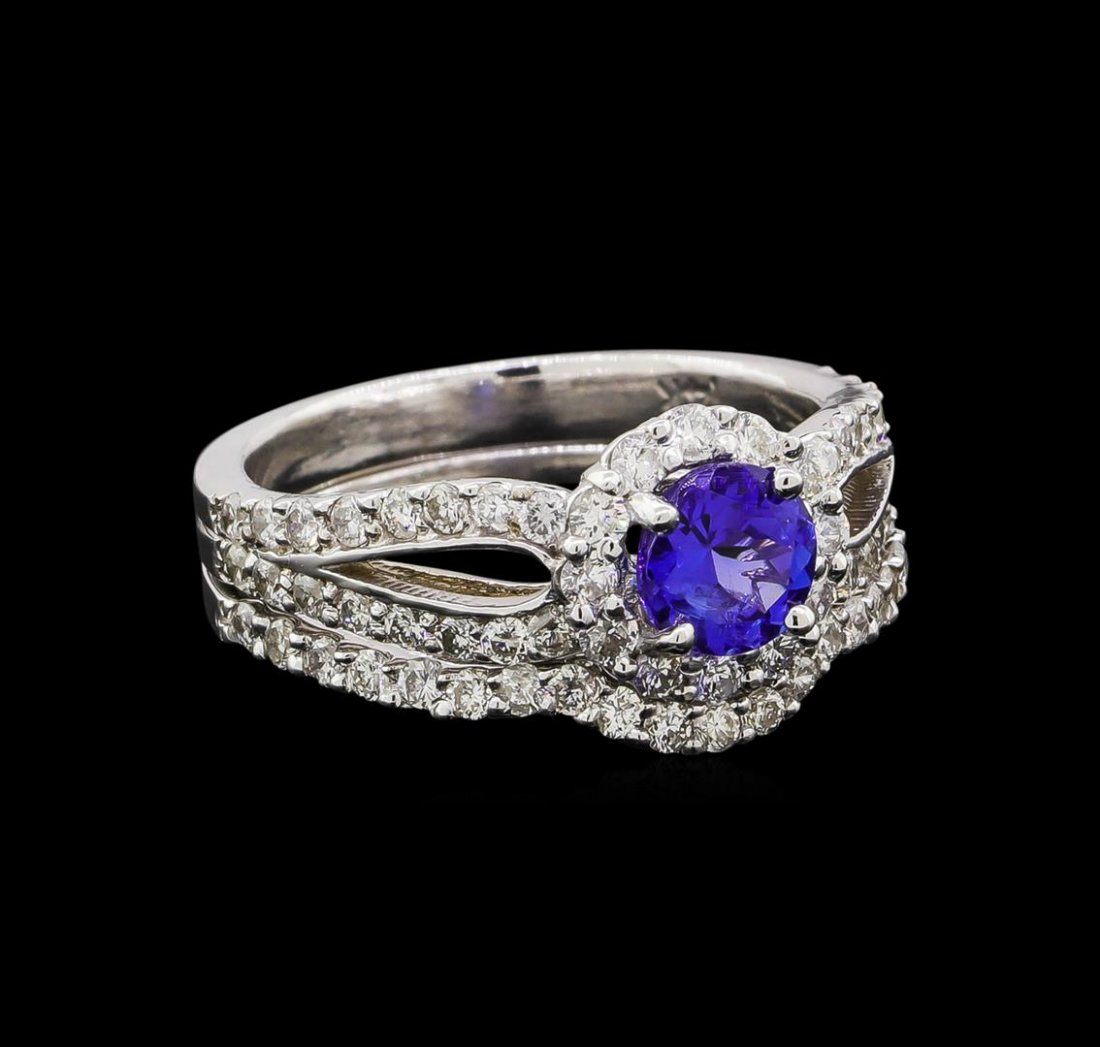 14KT White Gold 0.73 ctw Tanzanite and Diamond Wedding: One electronically tested 14KT white gold ladies cast tanzanite and diamond engagement ring & guard set with a bright polish finish. Identified with markings of "14K". Condition is new. Containing: On