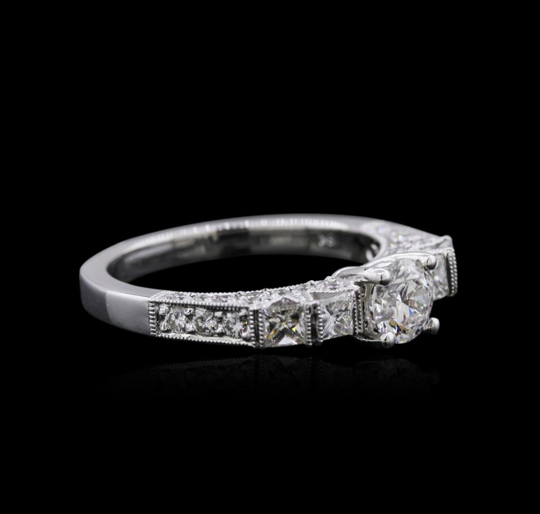 18KT White Gold 1.21 ctw Diamond Ring: One electronically tested 18KT white gold ladies cast diamond engagement ring with a bright polish finish. Identified with markings of "18K". Condition is new. Containing: One prong set round brillian