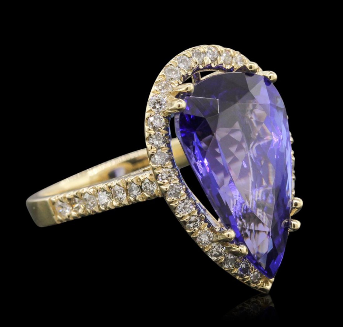 14KT Yellow Gold GIA Certified 8.69 ctw Tanzanite and: One electronically tested 14KT yellow gold ladies cast tanzanite and diamond ring with a bright polish finish. Condition is new, good workmanship. The featured tanzanite is set within a diamond bezel 